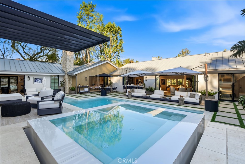 a swimming pool view with a seating space