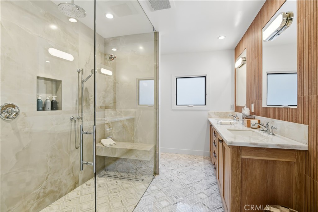 5565 Jed Smith Road Hidden Hills, CA 91302 - Photo 17 of 31 a bathroom with a granite countertop sink mirror and shower