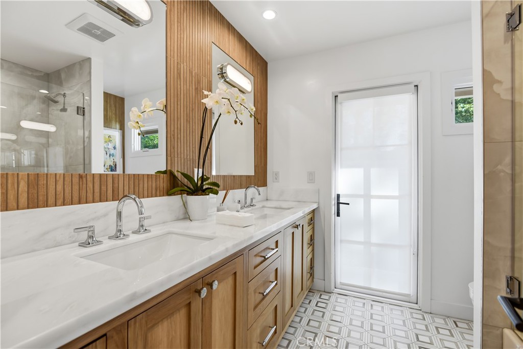 5565 Jed Smith Road Hidden Hills, CA 91302 - Photo 20 of 31 a bathroom with a double vanity sink a and a mirror