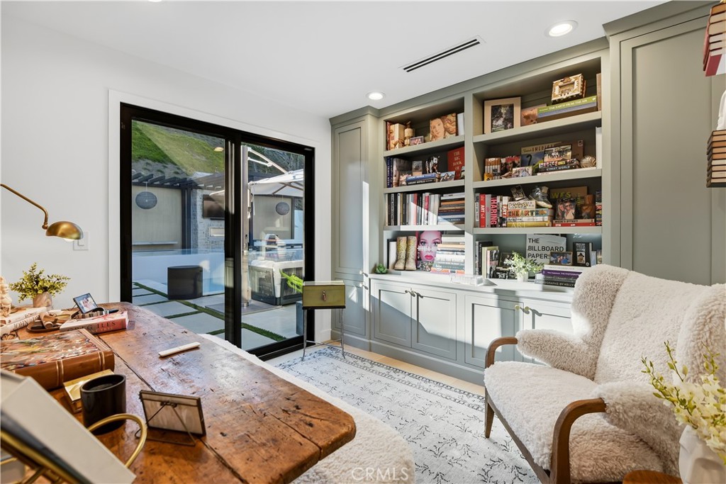 5565 Jed Smith Road Hidden Hills, CA 91302 - Photo 21 of 31 a living room with furniture and a book shelf