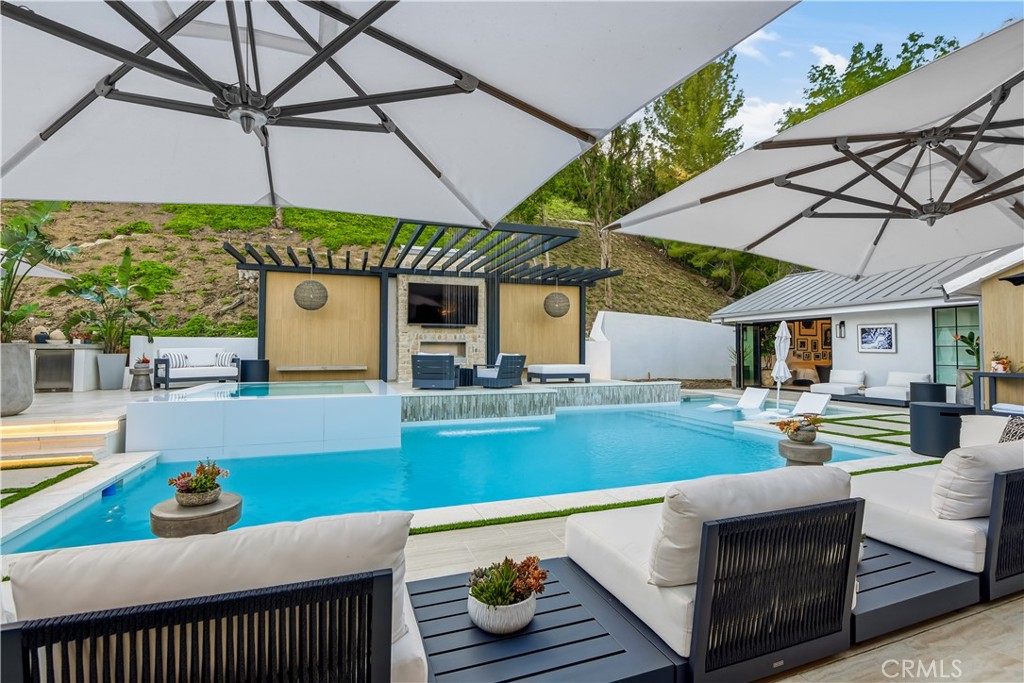 5565 Jed Smith Road Hidden Hills, CA 91302 - Photo 27 of 31 a view of a patio with table and chairs under an umbrella