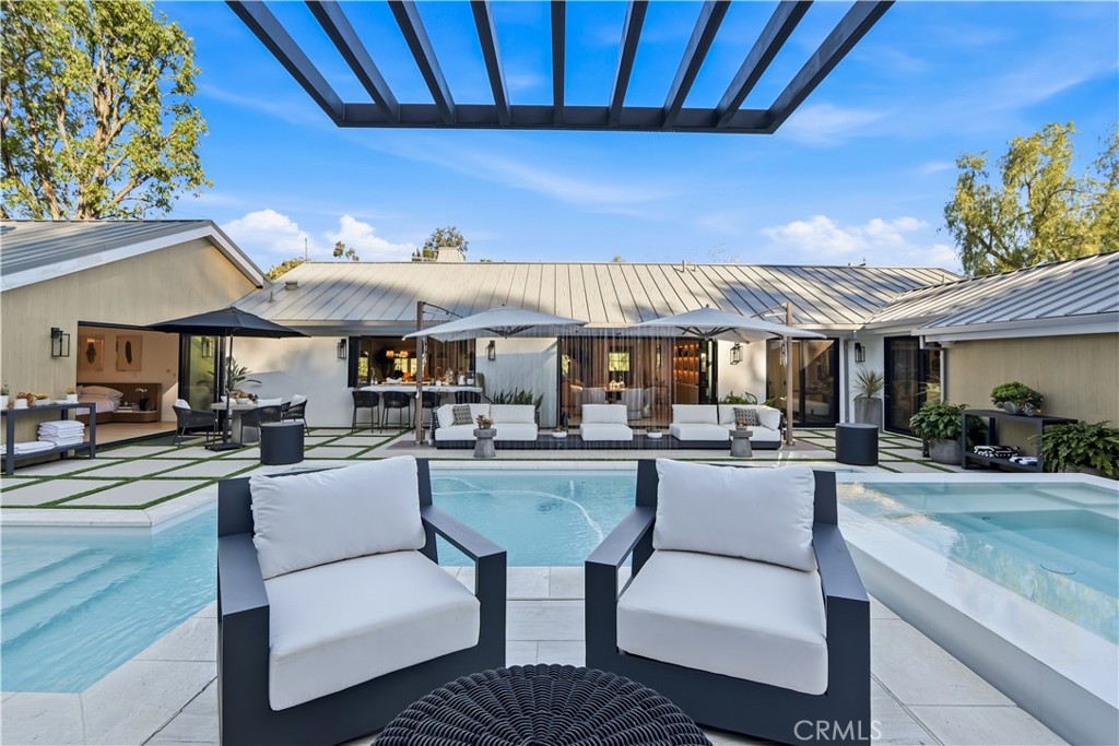 5565 Jed Smith Road Hidden Hills, CA 91302 - Photo 30 of 31 a view of a patio with dining table and chairs under an umbrella with a barbeque grill and couches