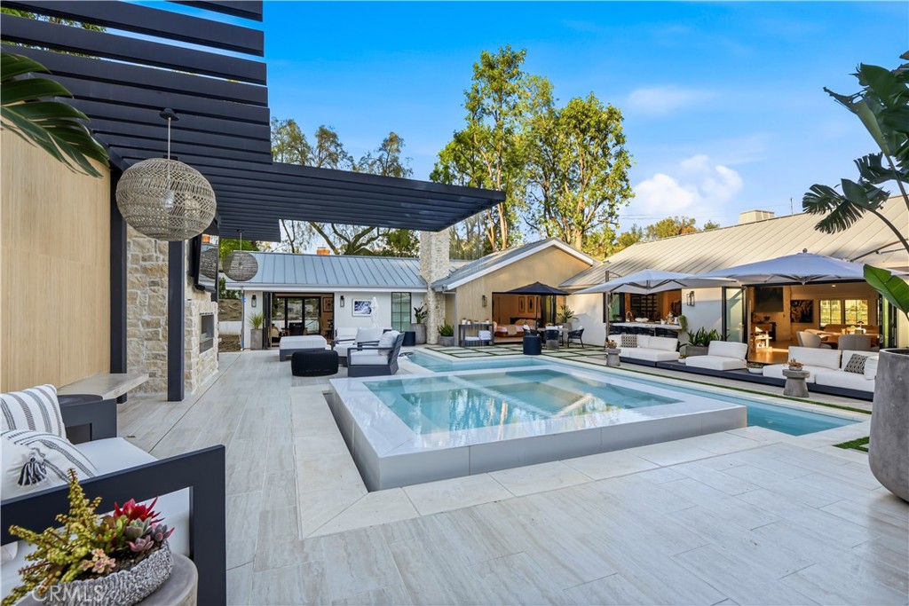 5565 Jed Smith Road Hidden Hills, CA 91302 - Photo 31 of 31 a view of a house with table and chairs under an umbrella