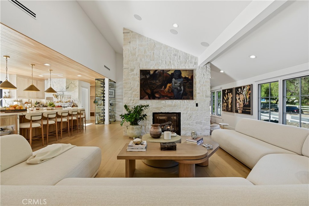 5565 Jed Smith Road Hidden Hills, CA 91302 - Photo 4 of 31 a living room with furniture a flat screen tv and a fireplace