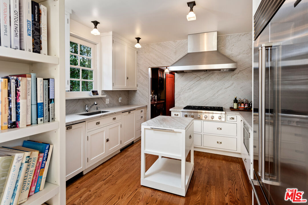 1663 Wellington Road Los Angeles, CA 90019 - Photo 11 of 45 a kitchen with appliances cabinets and a sink