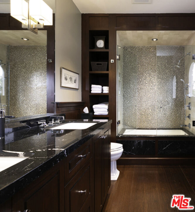 1663 Wellington Road Los Angeles, CA 90019 - Photo 25 of 45 a bathroom with a granite countertop sink and a mirror