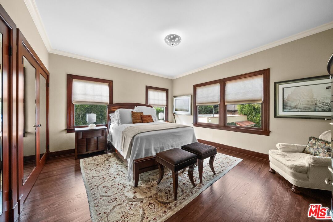 1663 Wellington Road Los Angeles, CA 90019 - Photo 27 of 45 a bedroom with a bed and wooden floor