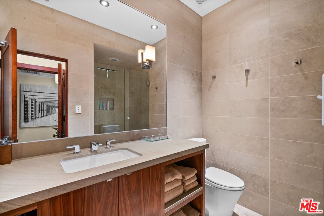 1663 Wellington Road Los Angeles, CA 90019 - Photo 29 of 45 a bathroom with a sink toilet vanity and shower