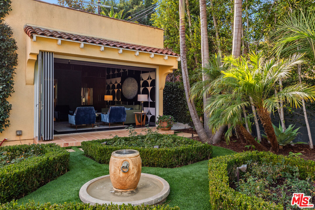 1663 Wellington Road Los Angeles, CA 90019 - Photo 31 of 45 a view of a chair and table in front of house