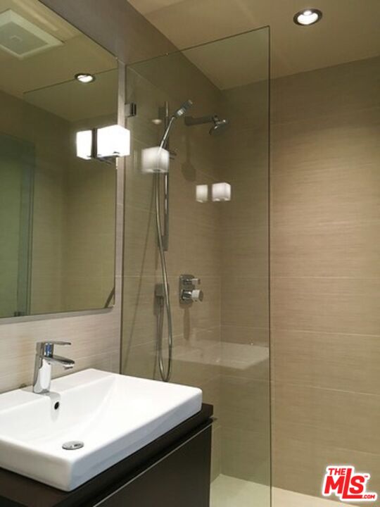 1663 Wellington Road Los Angeles, CA 90019 - Photo 34 of 45 a bathroom with a sink and a mirror