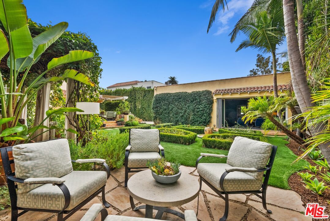 1663 Wellington Road Los Angeles, CA 90019 - Photo 41 of 45 a view of a patio with couches potted plants and a big yard