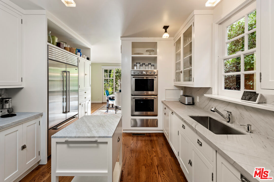 1663 Wellington Road Los Angeles, CA 90019 - Photo 10 of 45 a large kitchen with stainless steel appliances granite countertop a stove and a sink