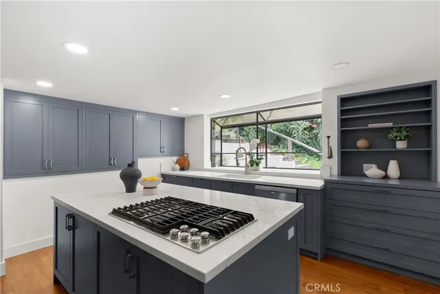 a kitchen with a stove a sink and a refrigerator