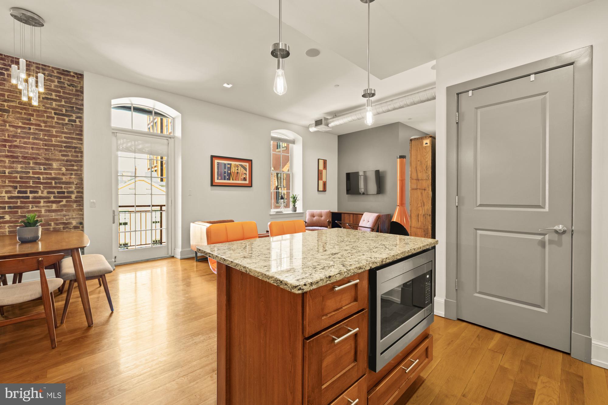 215 I Street Northeast, Unit 311 Washington, DC 20002 - Photo 11 of 38 a kitchen with a stove a counter top space and living room view