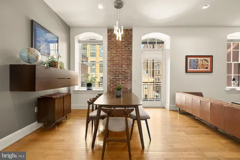 a bedroom with a large bed chandelier and a window