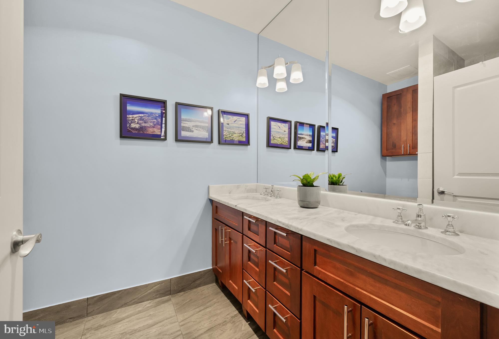 215 I Street Northeast, Unit 311 Washington, DC 20002 - Photo 17 of 38 a bathroom with a granite countertop double vanity and a mirror