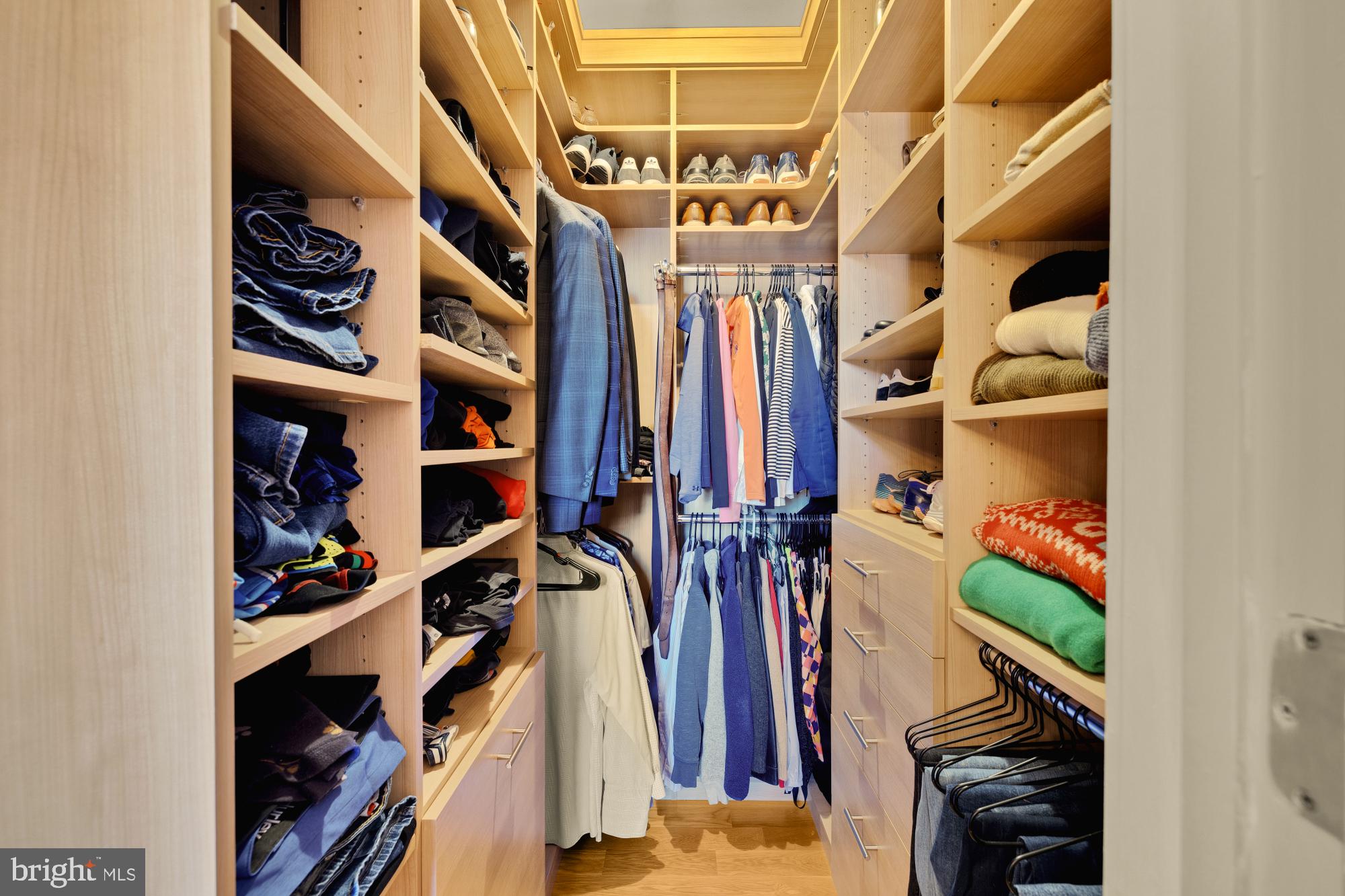 215 I Street Northeast, Unit 311 Washington, DC 20002 - Photo 19 of 38 a view of walk in closet with clothes and shoes