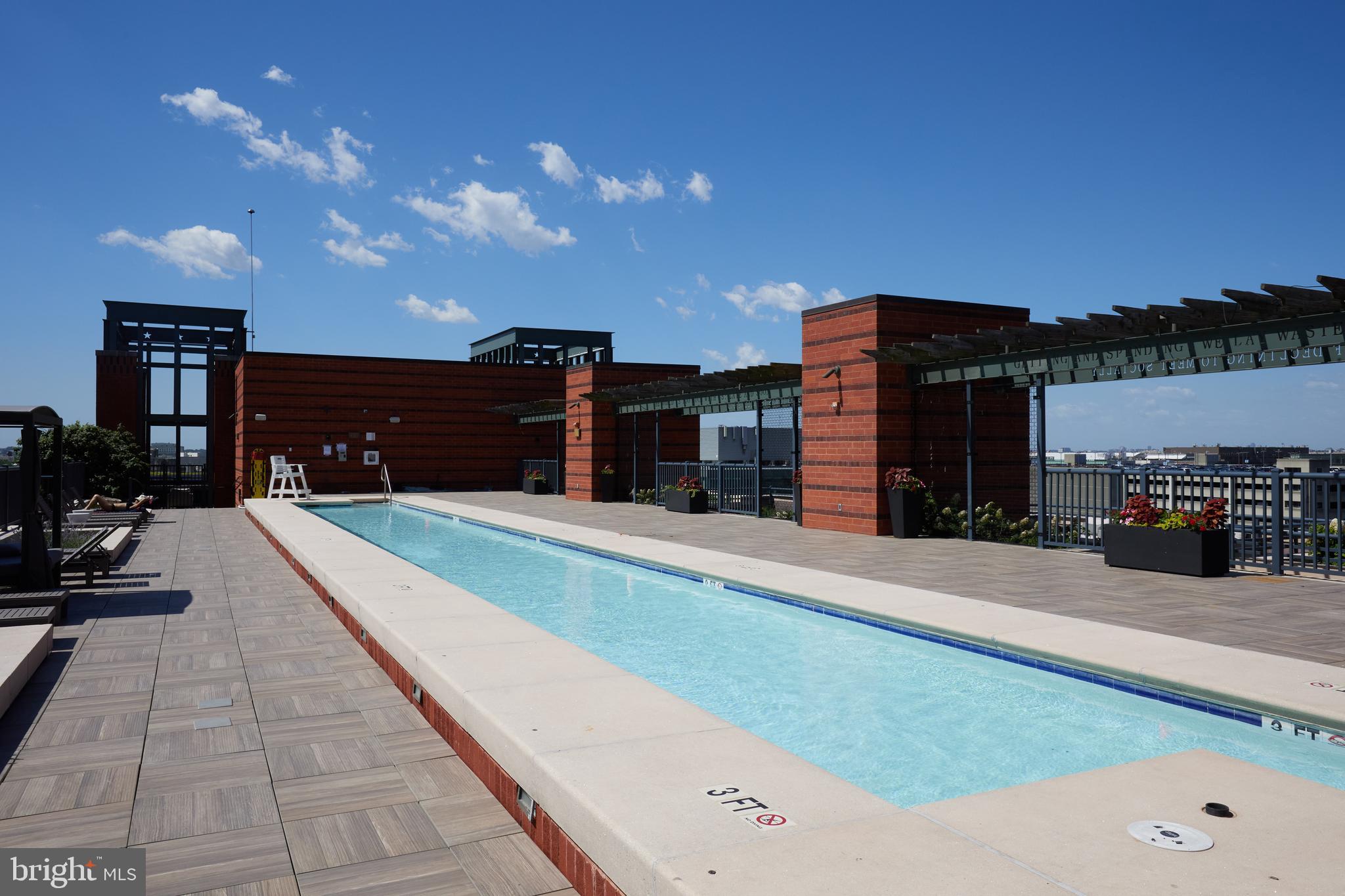 215 I Street Northeast, Unit 311 Washington, DC 20002 - Photo 26 of 38 a swimming pool with outdoor seating and yard in the back