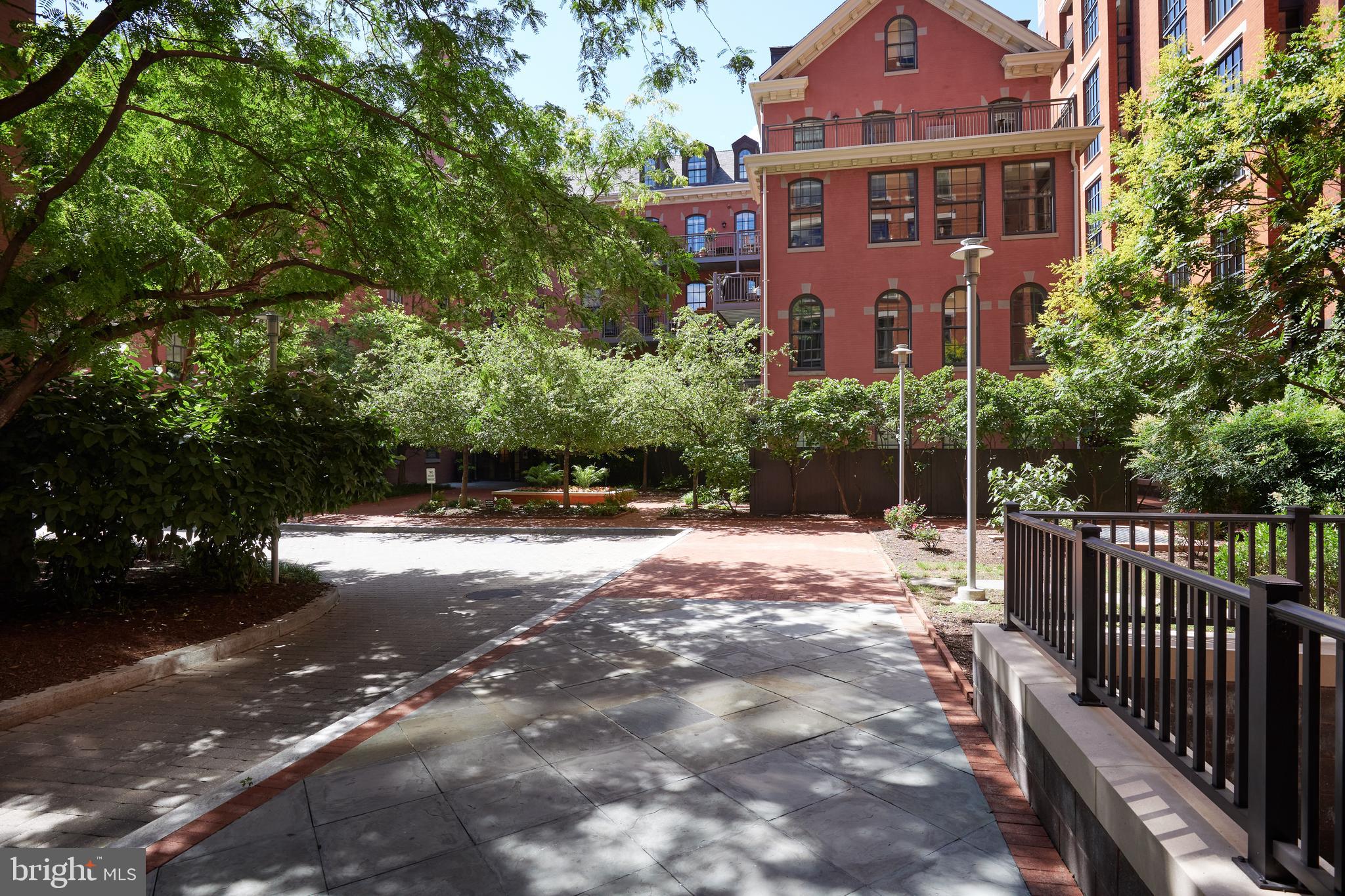 215 I Street Northeast, Unit 311 Washington, DC 20002 - Photo 29 of 38 a view of a brick building next to a yard