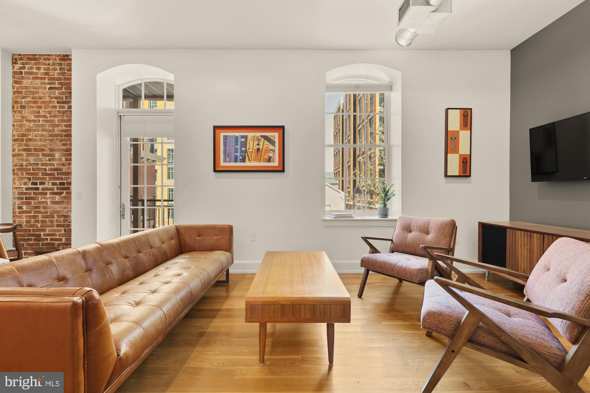 215 I Street Northeast, Unit 311 Washington, DC 20002 - Photo 5 of 38 a living room with furniture and a flat screen tv