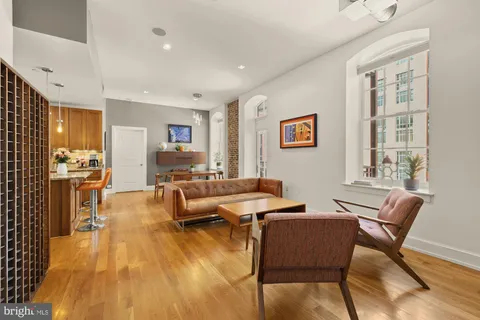 a living room with furniture and wooden floor