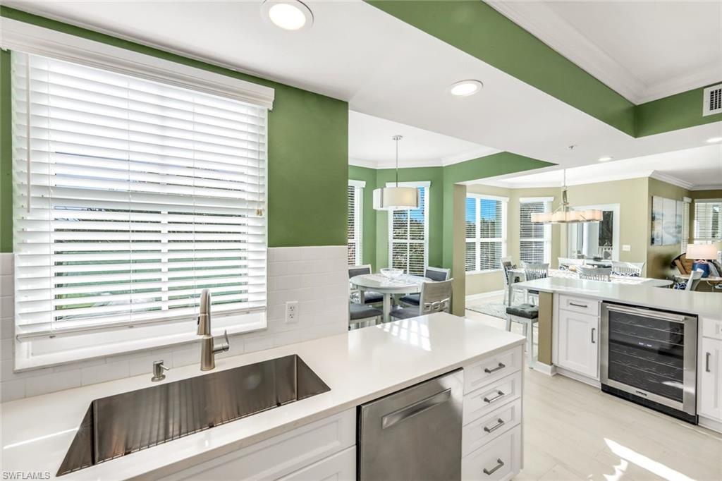 300 Dunes Boulevard, Unit 201 Naples, FL 34110 - Photo 17 of 50 a kitchen with sink attached with living room