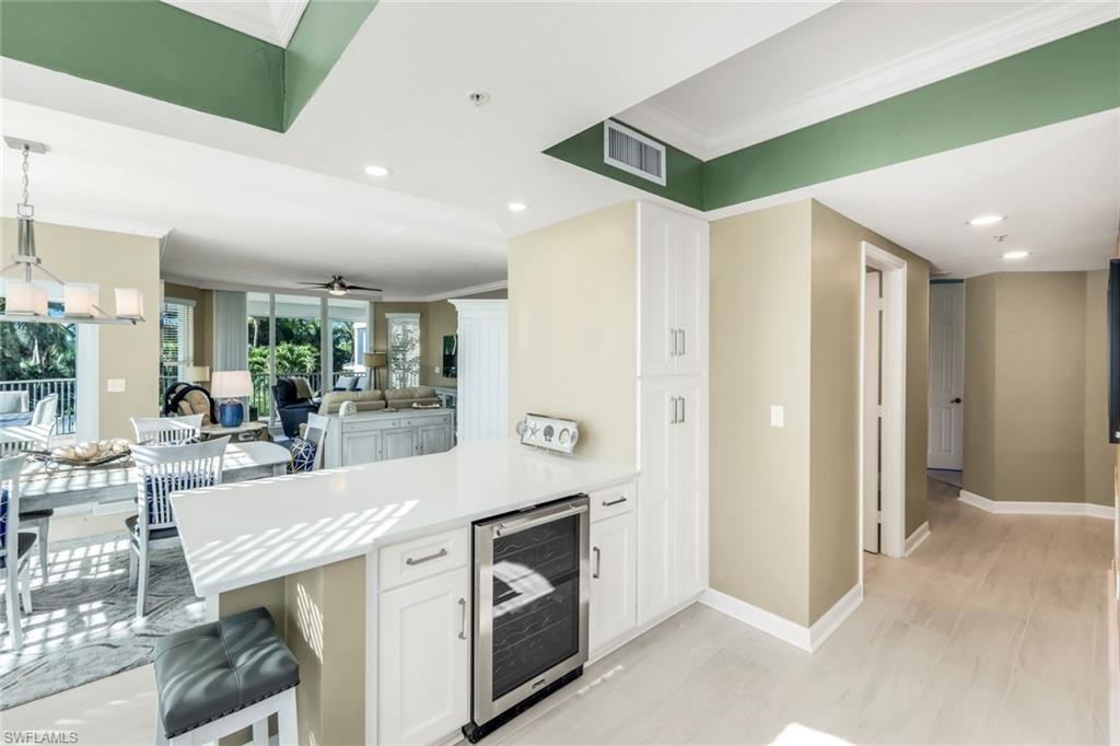 300 Dunes Boulevard, Unit 201 Naples, FL 34110 - Photo 18 of 50 a view of a kitchen with stainless steel appliances granite countertop a refrigerator and cabinets