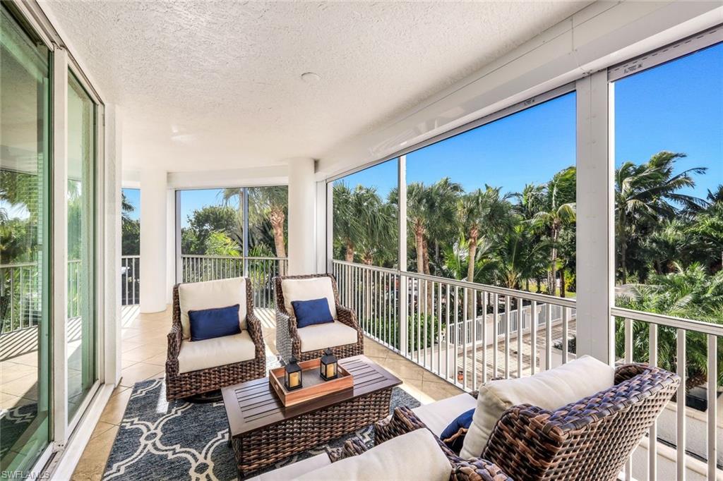 300 Dunes Boulevard, Unit 201 Naples, FL 34110 - Photo 2 of 50 a outdoor living space with furniture and a potted plant