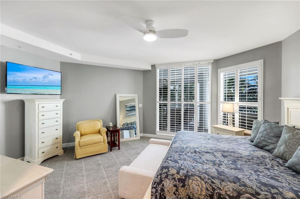 300 Dunes Boulevard, Unit 201 Naples, FL 34110 - Photo 20 of 50 a bedroom with a bed and a large window