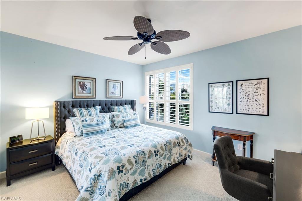 300 Dunes Boulevard, Unit 201 Naples, FL 34110 - Photo 22 of 50 a bedroom with a large bed and a window