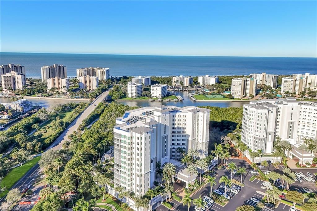 300 Dunes Boulevard, Unit 201 Naples, FL 34110 - Photo 31 of 50 a view of a balcony with furniture and a floor to ceiling window