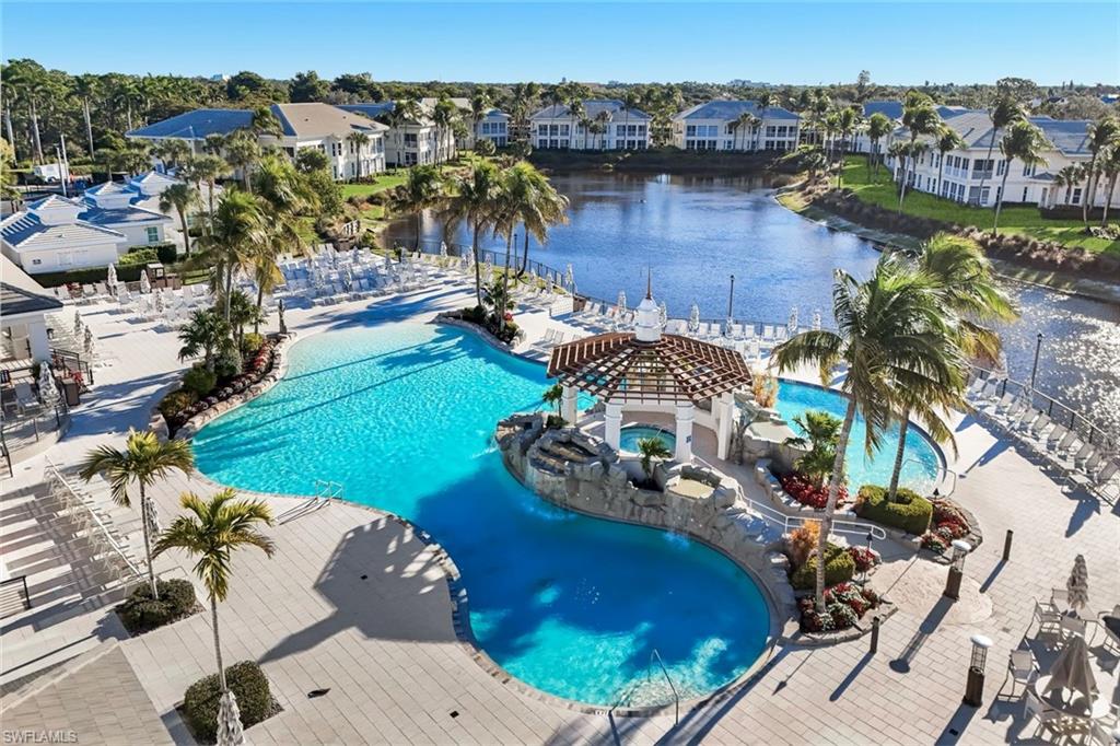 300 Dunes Boulevard, Unit 201 Naples, FL 34110 - Photo 35 of 50 a view of a swimming pool with lawn chairs