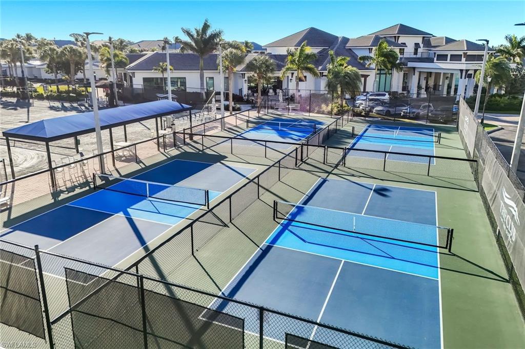 300 Dunes Boulevard, Unit 201 Naples, FL 34110 - Photo 37 of 50 a view of a balcony with chairs and wooden floor