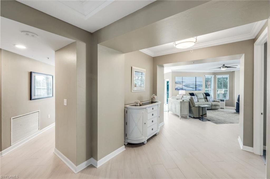 300 Dunes Boulevard, Unit 201 Naples, FL 34110 - Photo 6 of 50 a living room with furniture and large mirror