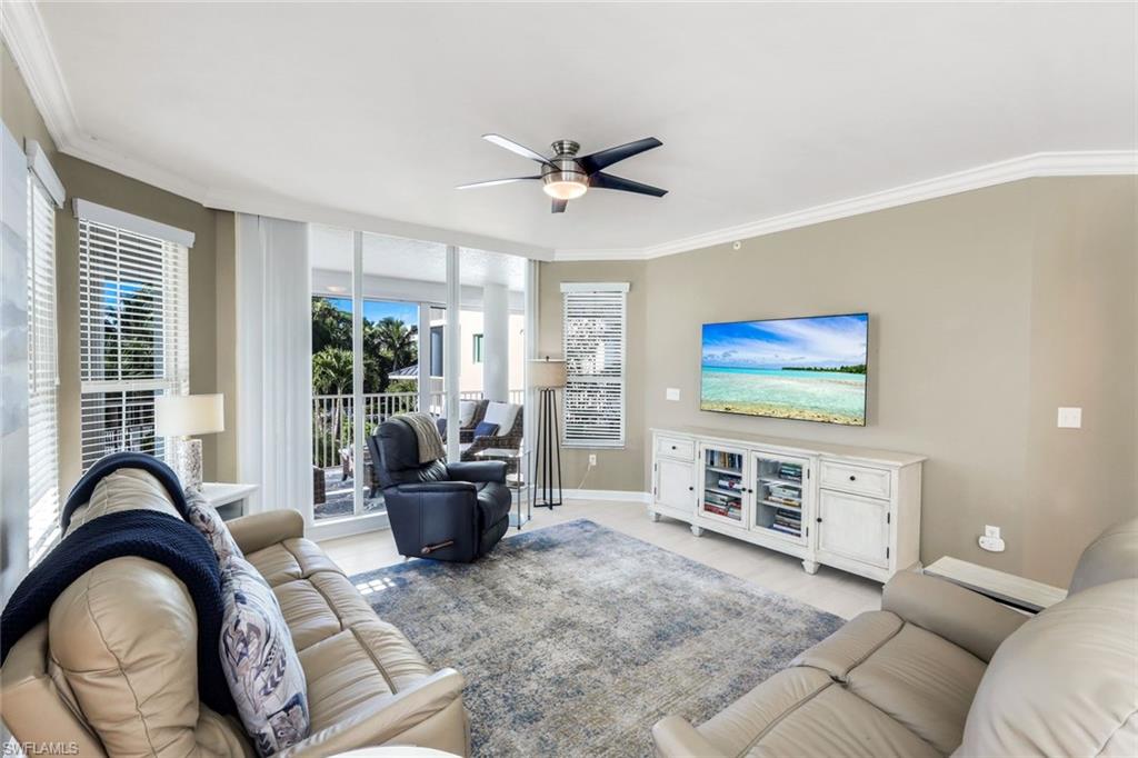 300 Dunes Boulevard, Unit 201 Naples, FL 34110 - Photo 8 of 50 a living room with furniture and a flat screen tv