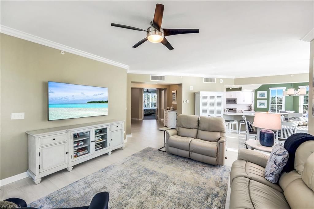 300 Dunes Boulevard, Unit 201 Naples, FL 34110 - Photo 9 of 50 a living room with furniture and a flat screen tv