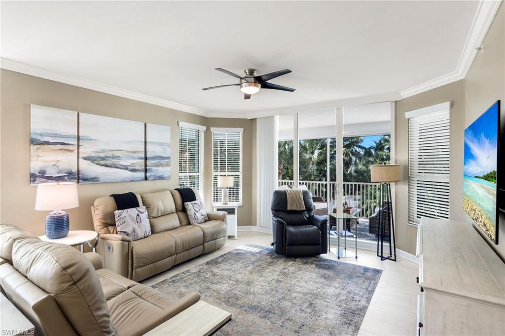 300 Dunes Boulevard, Unit 201 Naples, FL 34110 - Photo 10 of 50 a living room with furniture and large windows
