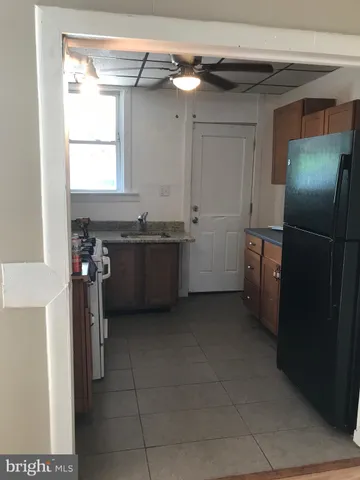 a view of an empty room with wooden floor and closet