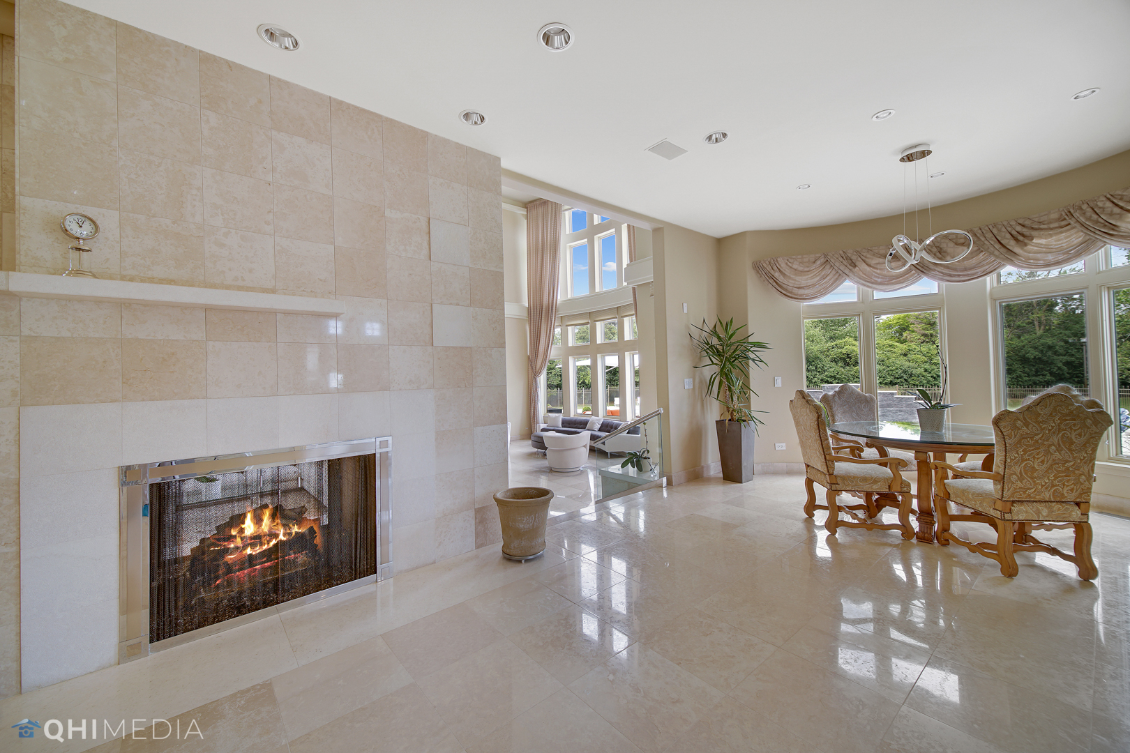 Undisclosed Address Oak Brook, IL 60523 - Photo 12 of 65 a living room with furniture a fireplace and a floor to ceiling window
