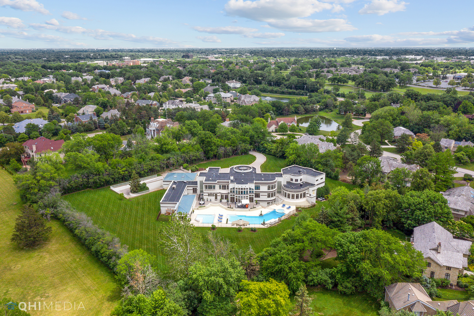 Undisclosed Address Oak Brook, IL 60523 - Photo 3 of 65 an aerial view of a house with a garden and lake view