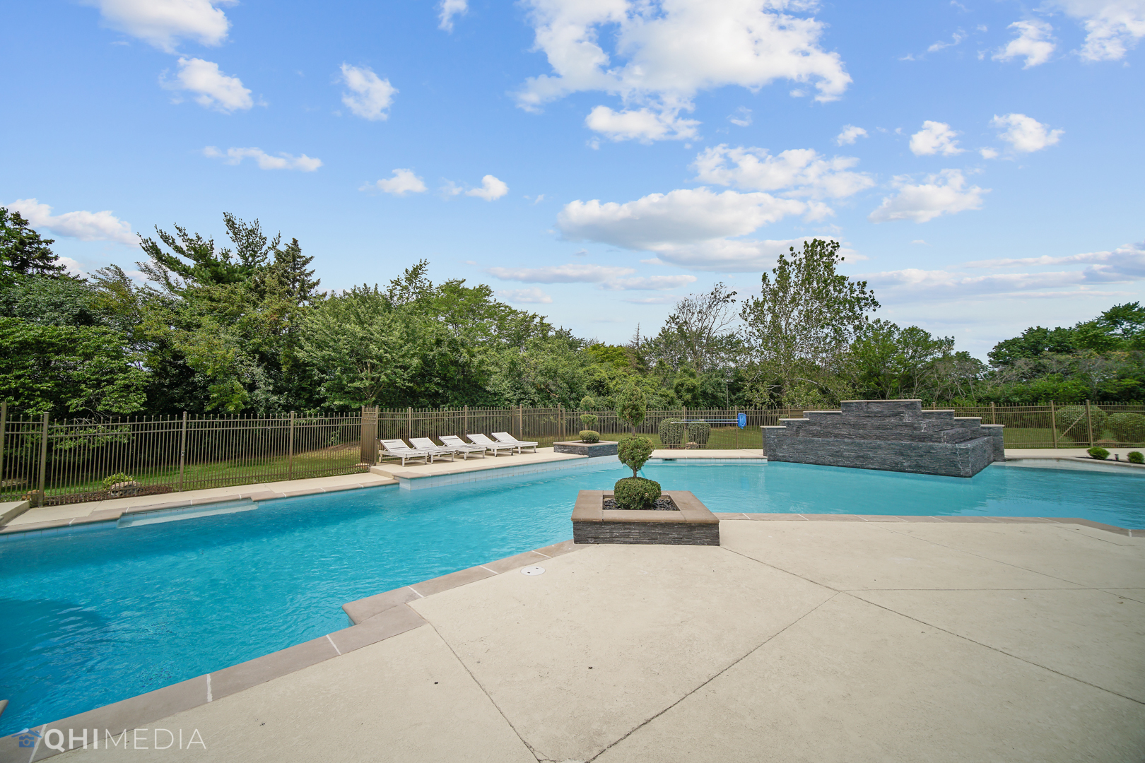 Undisclosed Address Oak Brook, IL 60523 - Photo 38 of 65 a view of swimming pool with seating area and trees in the background