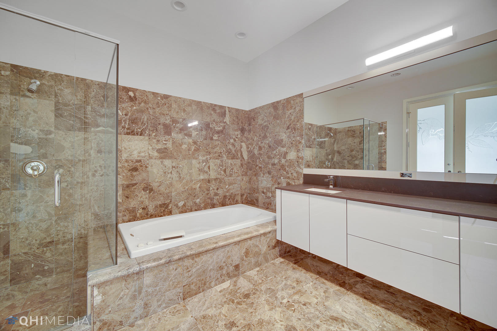 Undisclosed Address Oak Brook, IL 60523 - Photo 50 of 65 a bathroom with a sink a toilet a mirror and shower