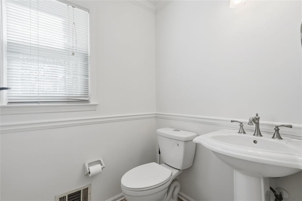 130 Spring Ridge Court Roswell, GA 30076 - Photo 11 of 47 a bathroom with a sink a toilet and a window