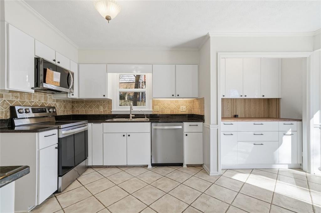 130 Spring Ridge Court Roswell, GA 30076 - Photo 12 of 47 a kitchen with white cabinets a sink and white appliances