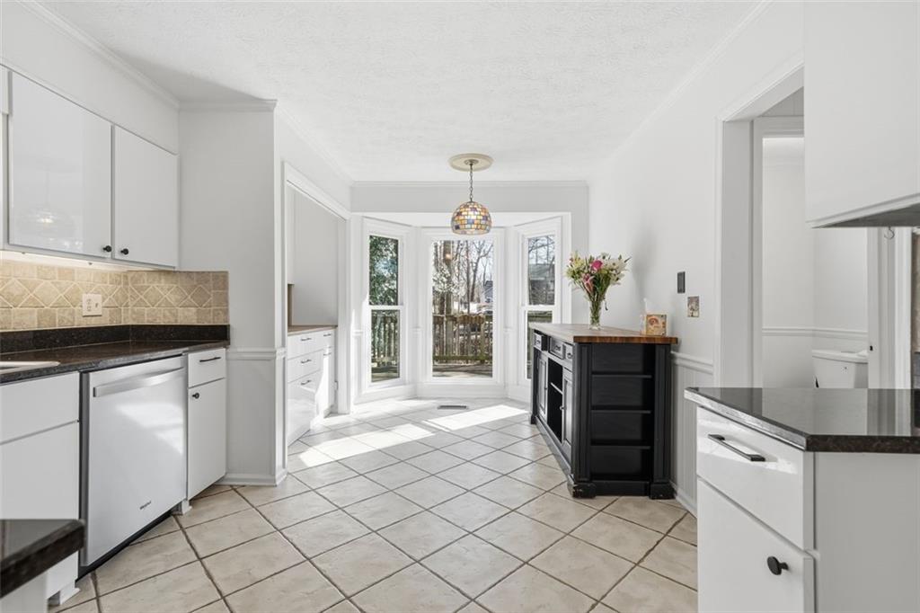 130 Spring Ridge Court Roswell, GA 30076 - Photo 13 of 47 a kitchen with granite countertop a refrigerator and a stove top oven