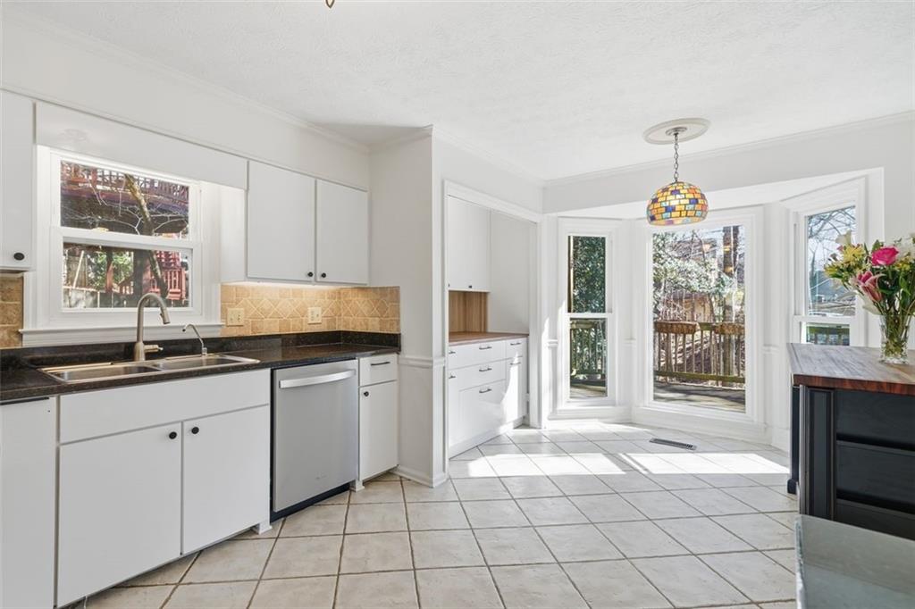 130 Spring Ridge Court Roswell, GA 30076 - Photo 14 of 47 a kitchen with granite countertop a sink window and cabinets