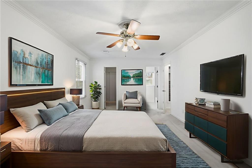 130 Spring Ridge Court Roswell, GA 30076 - Photo 19 of 47 a bedroom with a bed and a flat screen tv