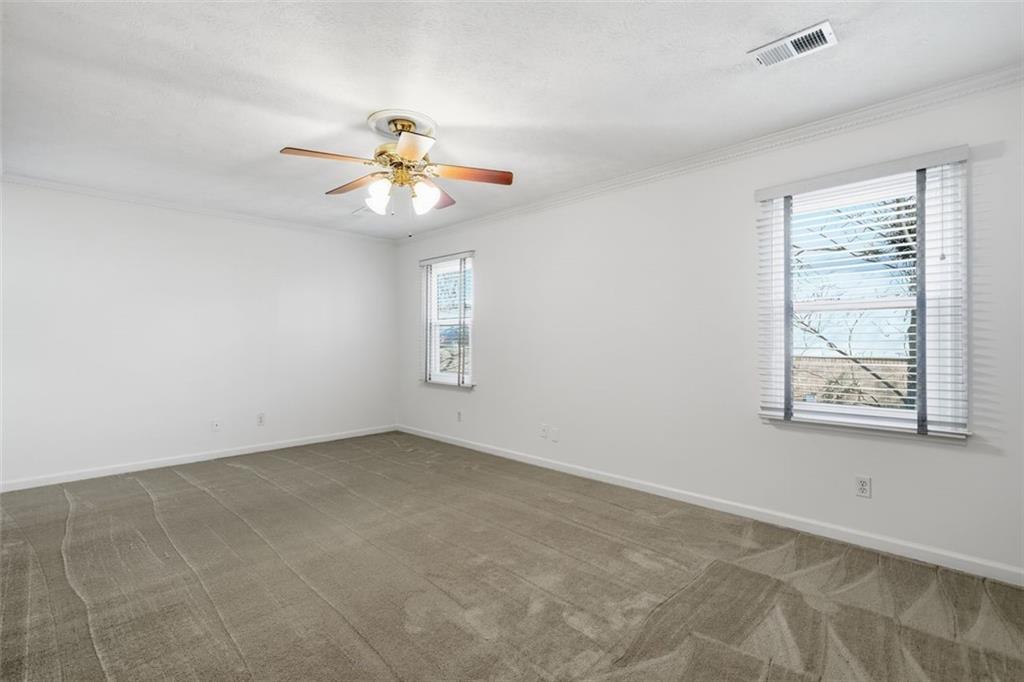 130 Spring Ridge Court Roswell, GA 30076 - Photo 21 of 47 an empty room with windows and fan