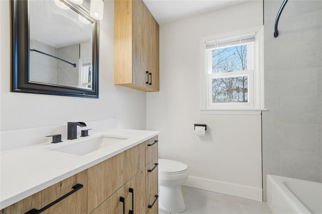 130 Spring Ridge Court Roswell, GA 30076 - Photo 22 of 47 a bathroom with a toilet a sink a vanity and mirror