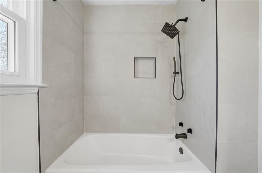 130 Spring Ridge Court Roswell, GA 30076 - Photo 23 of 47 a bathroom with a bath tub with a shower